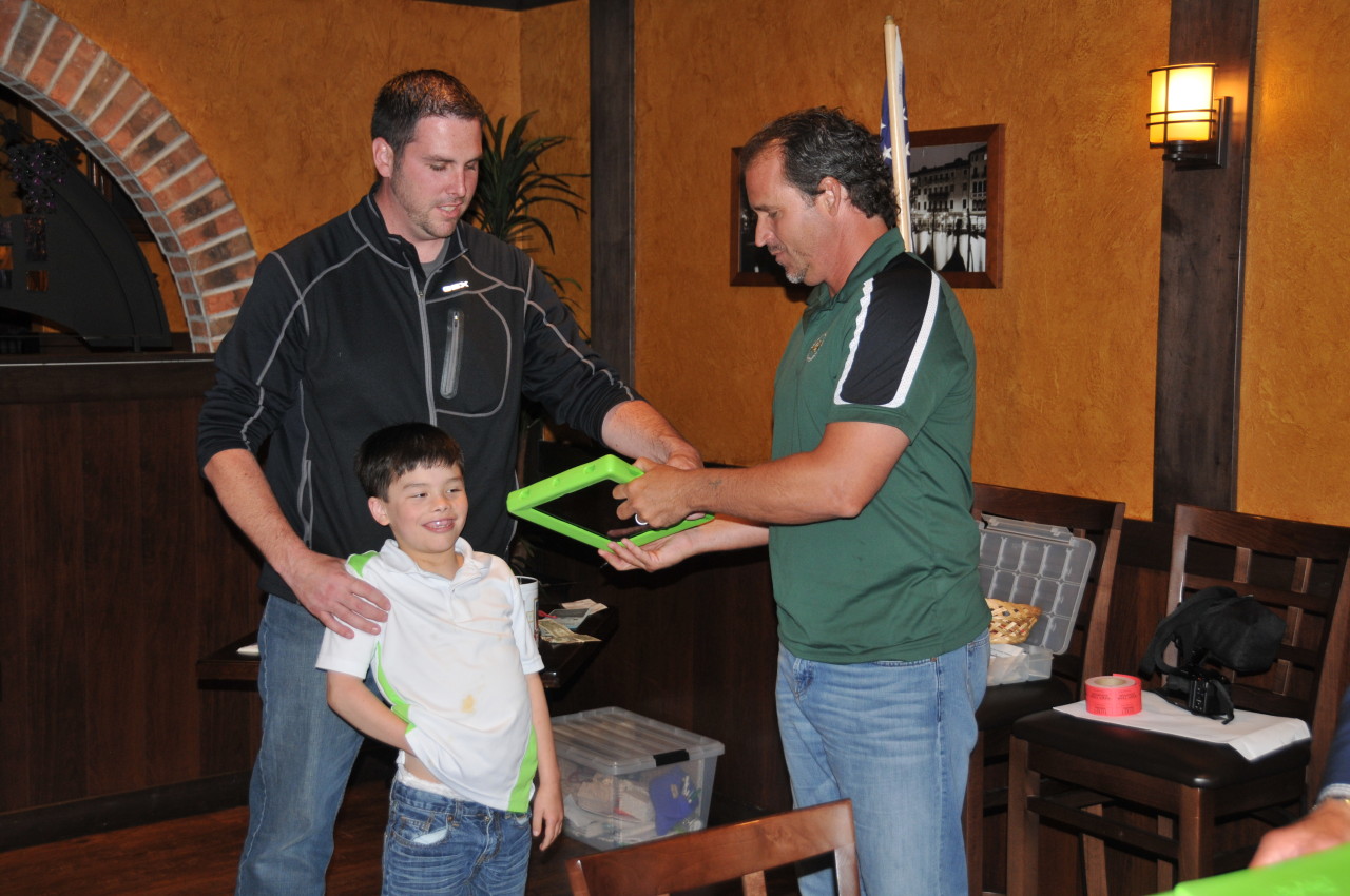 Aiden Kramer receives an iPad from Chris Jacke.