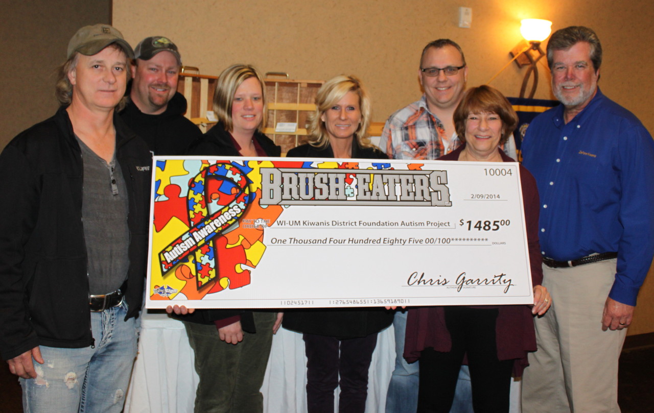 Brush Eaters LLC present Betsy Ingersoll with a very large check.
